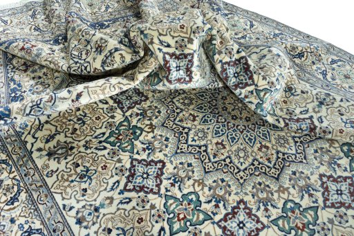 Surface texture of 2000s Nain rug with natural Wool and intricate pattern