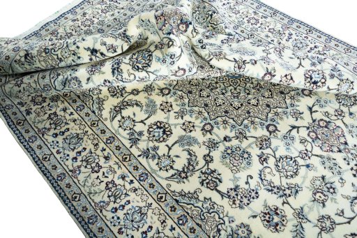 Surface texture of 2000s Nain rug with natural Wool and intricate pattern