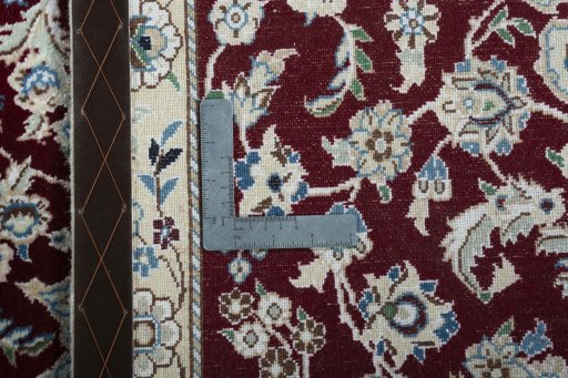 Backside of handmade New Nain rug showing knot structure and weave density