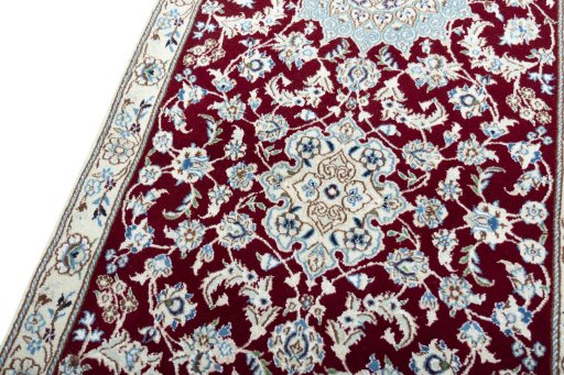 Backside of handmade New Nain rug showing knot structure and weave density