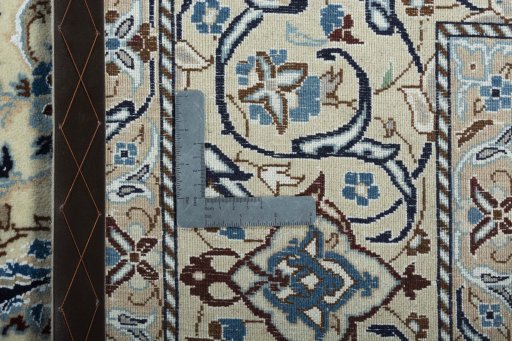 Backside of handmade New Nain rug showing knot structure and weave density