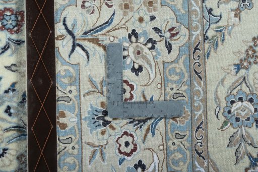 Backside of handmade New Nain rug showing knot structure and weave density