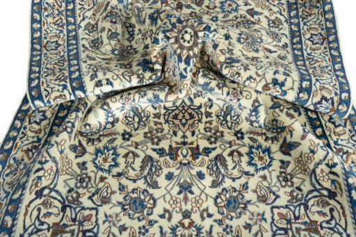 Surface texture of 2000s Nain rug with natural Wool and intricate pattern