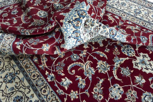 Surface texture of 2000s Nain rug with natural Wool and intricate pattern