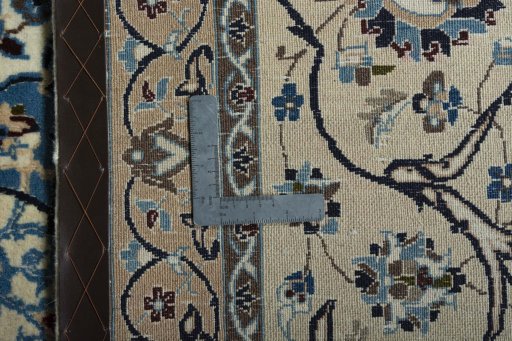 Backside of handmade 2000s Nain rug showing knot structure and weave density