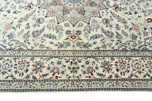 Corner detail of 2000s Nain rug showing border pattern and Wool pile