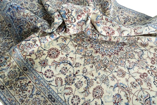 Surface texture of 2000s Nain rug with natural Wool and intricate pattern