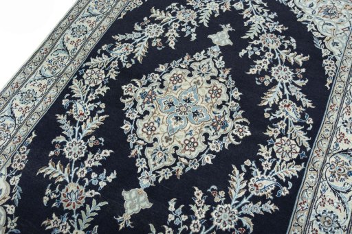 Backside of handmade New Nain rug showing knot structure and weave density