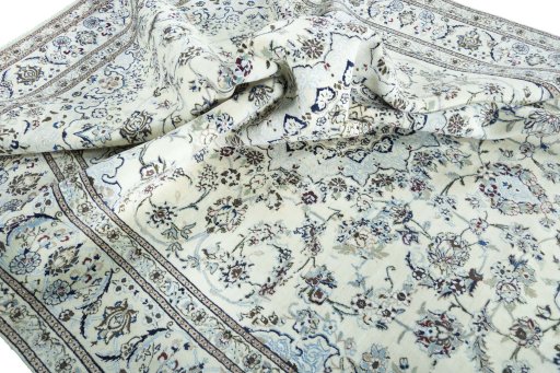 Surface texture of 2000s Nain rug with natural Wool and intricate pattern