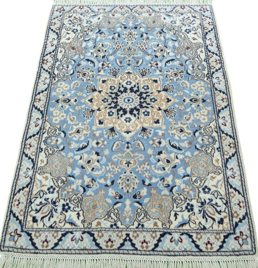 Surface texture of 2000s Nain rug with natural Wool and intricate pattern