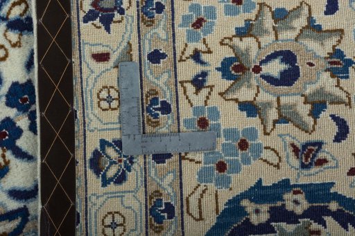 Backside of handmade 2000s Nain rug showing knot structure and weave density
