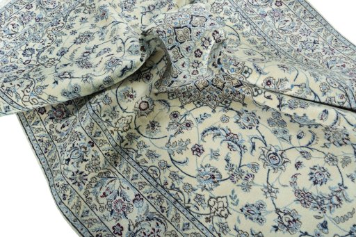 Surface texture of 2000s Nain rug with natural Wool and intricate pattern