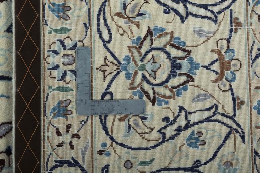 Backside of handmade New Nain rug showing knot structure and weave density
