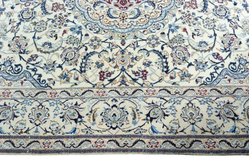 Corner detail of 2000s Nain rug showing border pattern and Wool pile