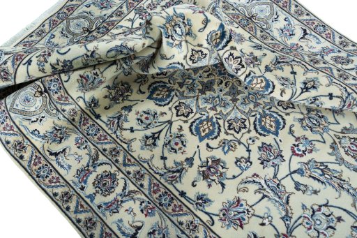 Surface texture of 2000s Nain rug with natural Wool and intricate pattern