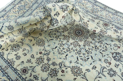 Surface texture of 2000s Nain rug with natural Wool and intricate pattern