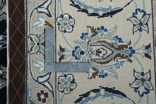 Backside of handmade New Nain rug showing knot structure and weave density