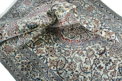 Surface texture of 2000s Nain rug with natural Wool and intricate pattern