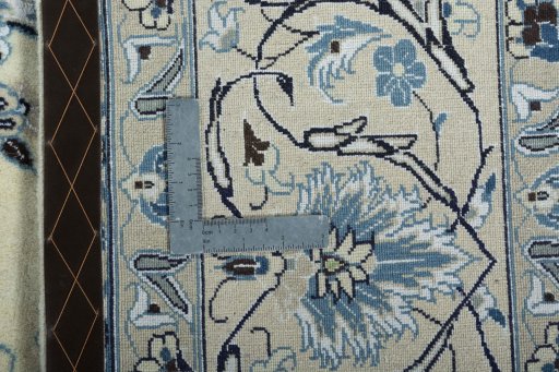 Backside of handmade New Nain rug showing knot structure and weave density