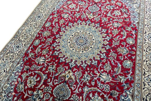 Backside of handmade New Nain rug showing knot structure and weave density