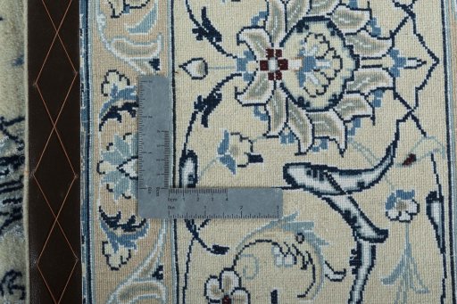 Backside of handmade New Nain rug showing knot structure and weave density