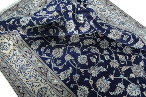Surface texture of 2000s Nain rug with natural Wool and intricate pattern