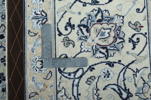 Backside of handmade New Nain rug showing knot structure and weave density