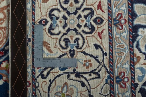 Backside of handmade 2000s Nain rug showing knot structure and weave density