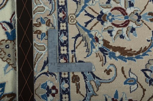 Backside of handmade New Nain rug showing knot structure and weave density