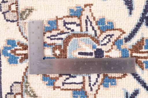 Surface texture of 1985s Nain rug with natural Wool and intricate pattern