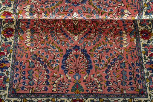 Corner detail of 2000s Sarough rug showing border pattern and Wool pile