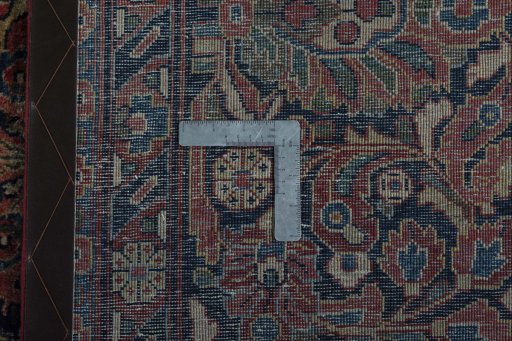 Backside of handmade 1930s Sarough rug showing knot structure and weave density