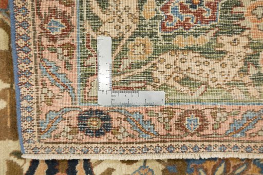 Corner detail of 1900s Tabriz rug showing border pattern and Wool pile