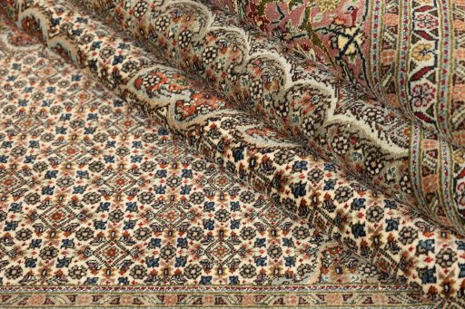 Full view of New Tabriz rug from Iran / Persia, 310 × 200 cm in Cream tones