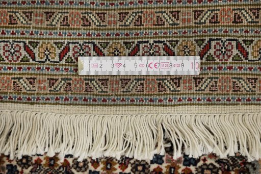 Corner detail of New Tabriz rug showing border pattern and Wool pile