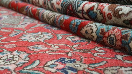 Full view of 1950s Tabriz rug from Iran / Persia, 556 × 350 cm in Red tones