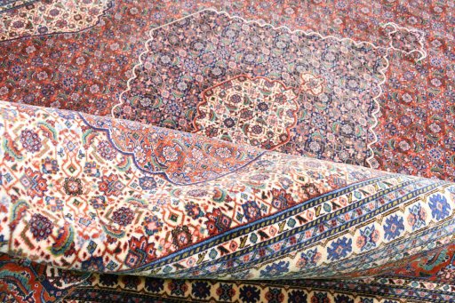 Corner detail of 2000s Tabriz rug showing border pattern and Wool pile
