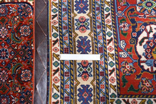 Close-up detail of 2000s Tabriz rug from Iran / Persia showing Wool weave