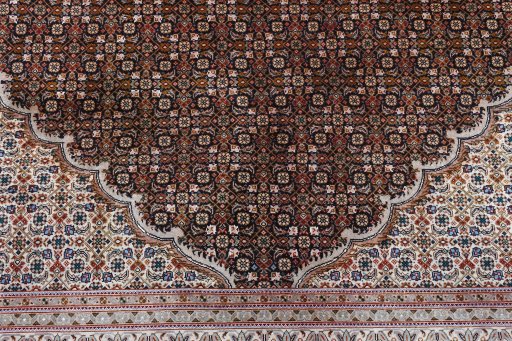 Corner detail of 2000s Tabriz rug showing border pattern and Cork pile