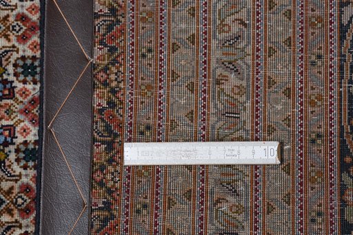 Backside of handmade 2000s Tabriz rug showing knot structure and weave density