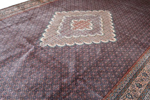 Corner detail of 2000s Tabriz rug showing border pattern and Wool pile