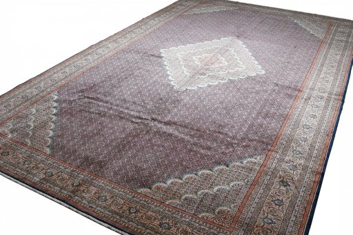 Corner detail of 2000s Tabriz rug showing border pattern and Wool pile