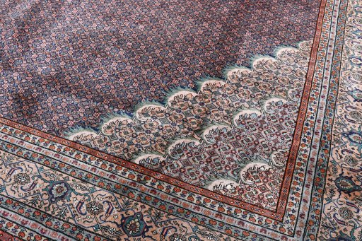 Surface texture of 2000s Tabriz rug with natural Wool and intricate pattern