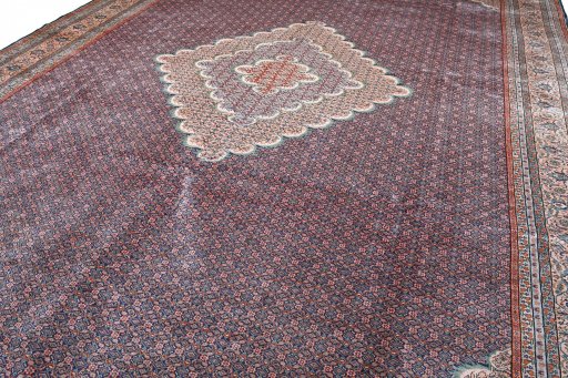 Backside of handmade 2000s Tabriz rug showing knot structure and weave density