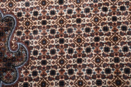 Close-up detail of New Tabriz rug from Iran / Persia showing Wool weave