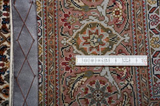 Backside of handmade New Tabriz rug showing knot structure and weave density