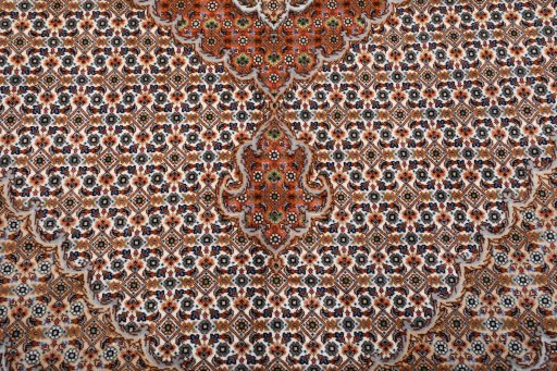 Backside of handmade New Tabriz rug showing knot structure and weave density