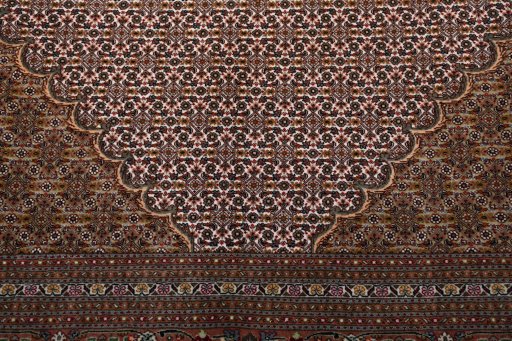 Backside of handmade New Tabriz rug showing knot structure and weave density