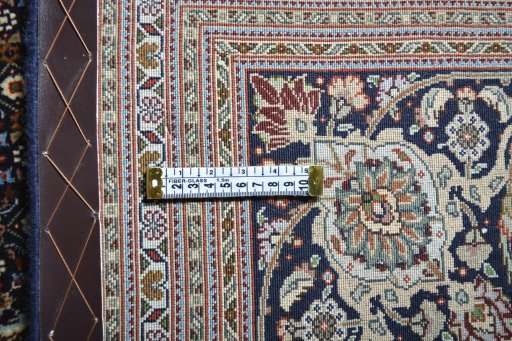 Backside of handmade 2000s Tabriz rug showing knot structure and weave density