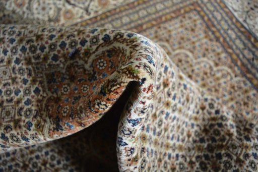 Surface texture of 2000s Tabriz rug with natural Cork and intricate pattern